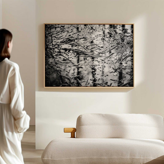 black and white nature photography print hanging above a stylish sofa in an elegant living room